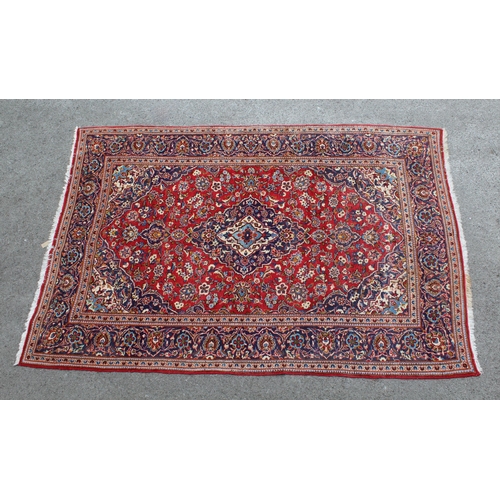 14 - Modern Kashan carpet with all-over floral decoration on a red ground with multiple borders