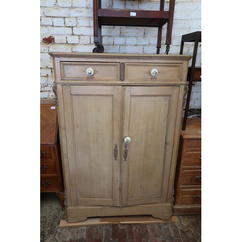 1475 - 19th Century pine low wardrobe with two short drawers above two panelled doors with later ceramic kn... 