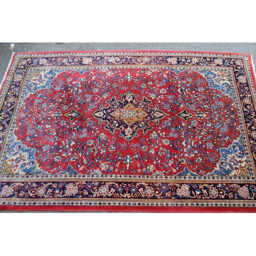 16 - Modern Kashan rug, with all-over floral design on red ground with borders