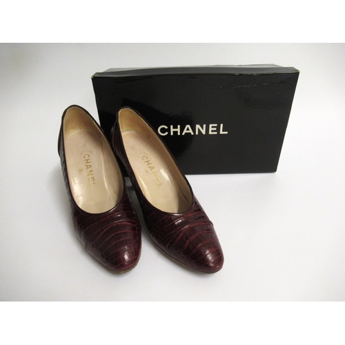 18 - Pair of ladies Chanel burgundy crocodile leather court shoes, marked size 7.5, with original box