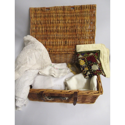 22 - Wicker hamper containing a collection of various table linen etc.