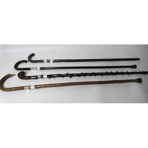 259 - Two knobbly shafted silver mounted walking canes, another similar and an ebony silver collared walki... 