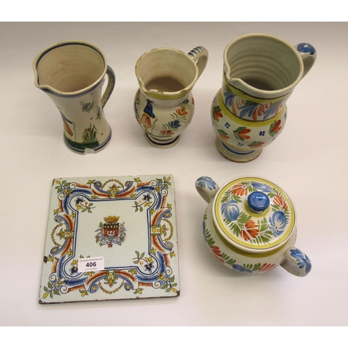 406 - Three Quimper pottery jugs, two handled jar and cover and a Sarreguemines pottery armorial tile