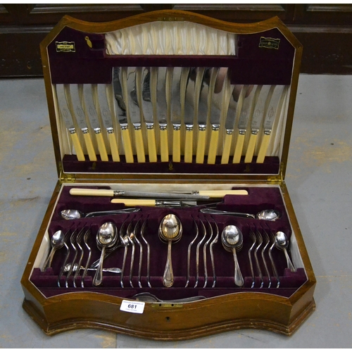 681 - Silver plated eight place setting canteen of cutlery, in a walnut serpentine fronted box