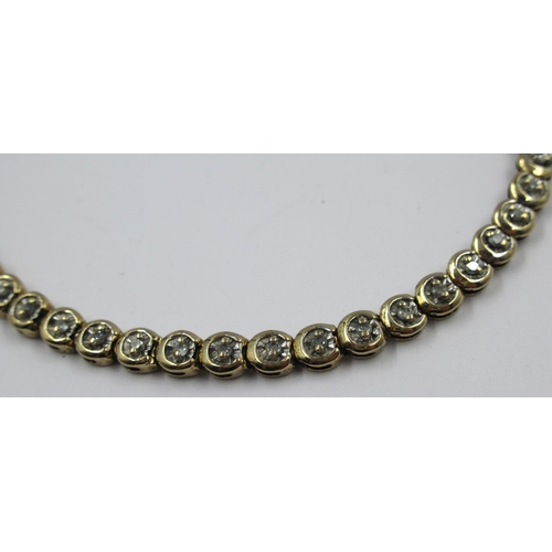 724 - 9ct Gold and diamond set line bracelet, 8g