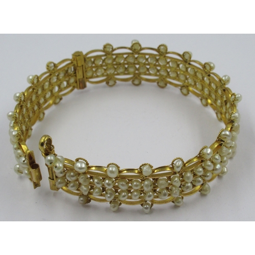 788 - Middle Eastern yellow metal and pearl bangle, 21.5g