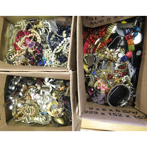 856 - Three boxes containing a collection of various costume jewellery