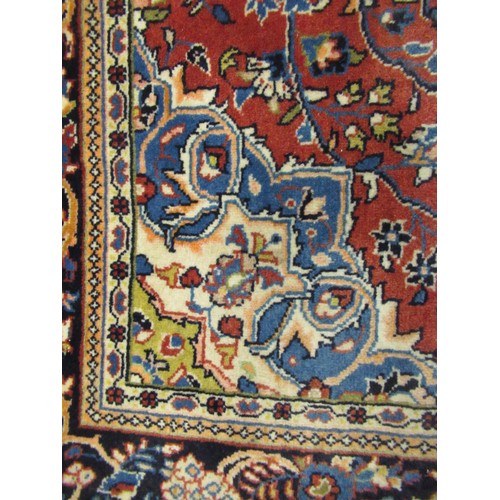 16 - Modern Kashan rug, with all-over floral design on red ground with borders