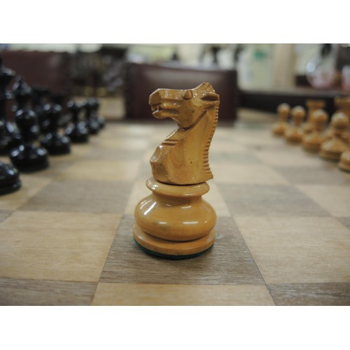 311 - Staunton pattern boxwood and ebony chest set, housed in a wooden box, together with a wooden chess b... 