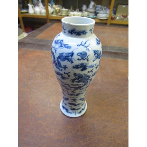 489 - Chinese baluster form vase with cover, blue and white decorated with dragons, 35cm high, together wi... 