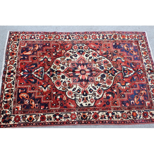 8 - Bakhtiari carpet having centre medallion and all-over floral design with multiple borders, 312cm x 2... 