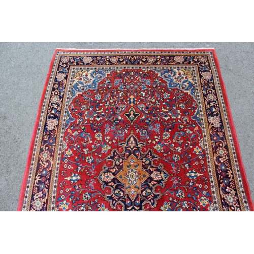 16 - Modern Kashan rug, with all-over floral design on red ground with borders