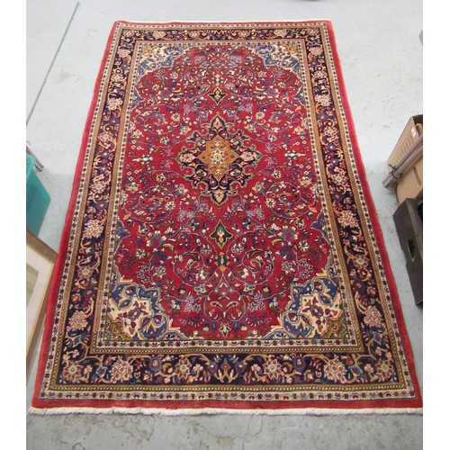 16 - Modern Kashan rug, with all-over floral design on red ground with borders