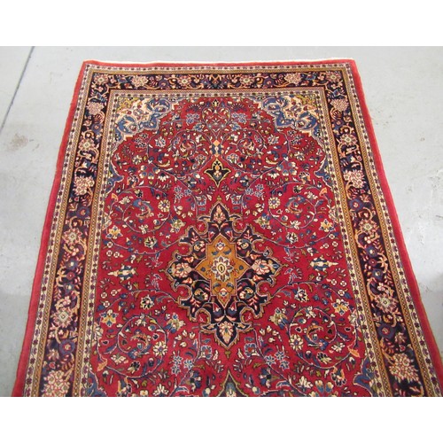 16 - Modern Kashan rug, with all-over floral design on red ground with borders