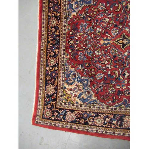 16 - Modern Kashan rug, with all-over floral design on red ground with borders