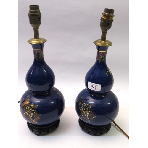 573 - Pair of chinoiserie table lamps on blue ground with buildings and trees, 30cm high