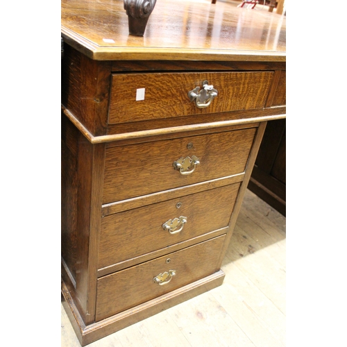 1211 - Early to mid 20th Century oak twin pedestal partners desk, the moulded top above an arrangement of v... 