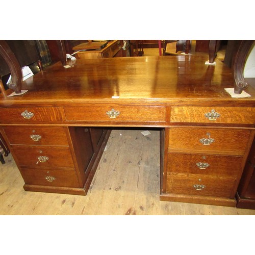 1211 - Early to mid 20th Century oak twin pedestal partners desk, the moulded top above an arrangement of v... 