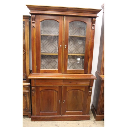 1312D - Reproduction mahogany bookcase, the moulded top above two arched top glazed doors, two frieze drawer... 