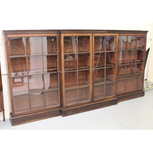 1399 - George III mahogany and oak dwarf breakfront bookcase having glazed doors on a plinth base, 310cm wi... 