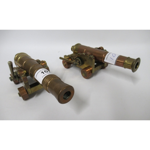 102 - Pair of small heavy brass and copper models of cannons on carriages, 17cm long each approximately