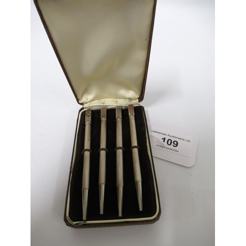 109 - Cased set of four silver bridge markers