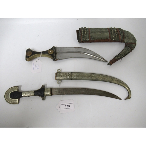 133 - Middle Eastern jambiya with scabbard, together with a North African dagger with scabbard