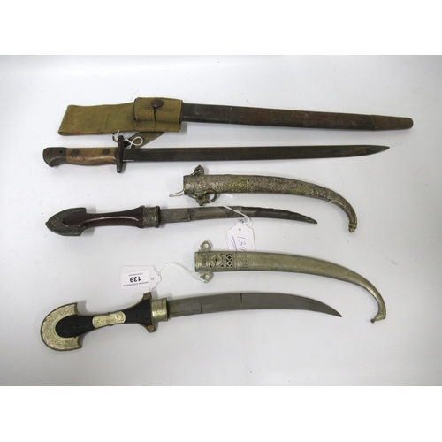 139 - Two Middle Eastern daggers with scabbards, together with a World War I bayonet