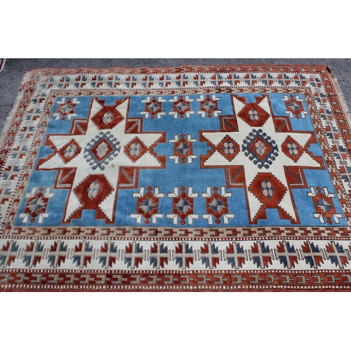 15 - Kazak rug, having two hooked medallions on a cream and pale blue ground with multiple borders, 1.5m ... 