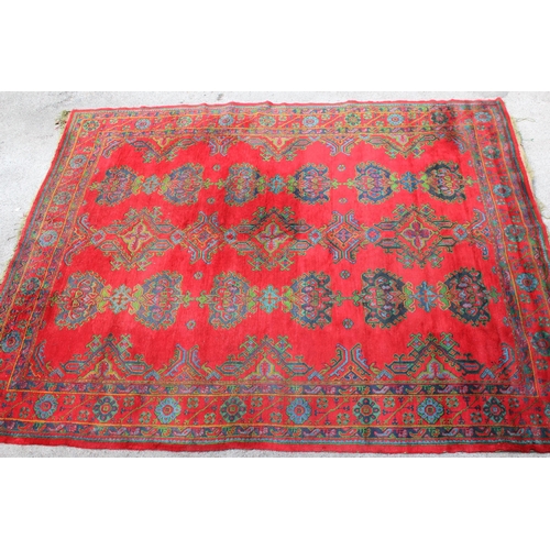 16 - Large Turkish carpet with Ushak design on a red ground with borders, 4m x 3m