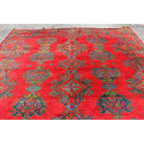 16 - Large Turkish carpet with Ushak design on a red ground with borders, 4m x 3m