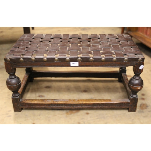 1682 - Rectangular oak stool with woven leather seat on turned baluster supports