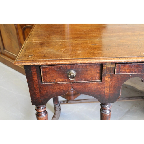 1687 - 18th Century oak side table, having an arrangement of three short drawers with brass ring handles on... 