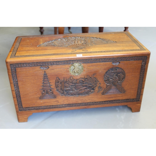 1694 - Mid 20th Century Eastern camphor wood trunk with hinged cover and carved decoration