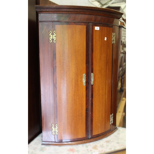 1699 - George III oak and mahogany two door bow front hanging corner cabinet