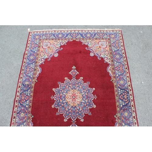 17 - Tabriz rug with centre medallion and multiple borders on a burgundy ground, 193 x 126cm