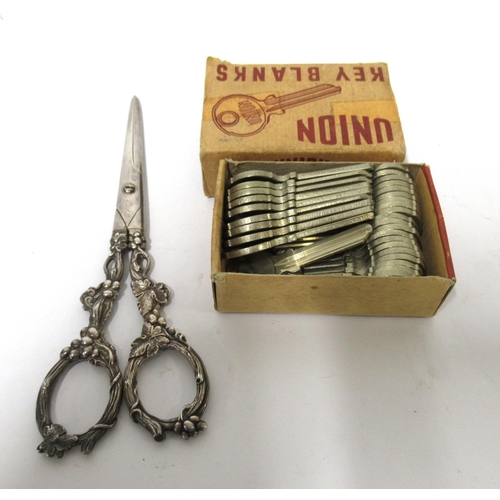 170 - Box of union key blanks and a pair of silver plated grape scissors with decorative handles