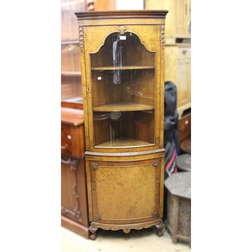 1700 - Mid 20th Century figured walnut bow front standing corner cabinet, with a glazed door above a panell... 