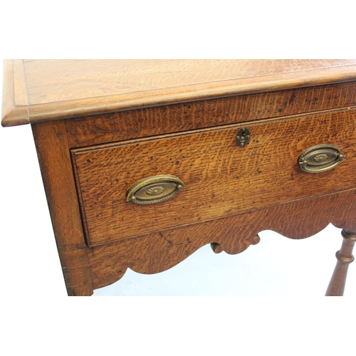 1740 - Small oak dresser base, the moulded top above two short drawers with oval brass handles and turned s... 