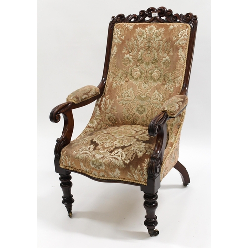 1749 - Victorian carved mahogany library chair, on turned tapering front supports with brass casters, 65cm ... 