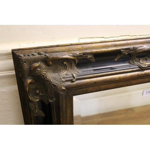 1750 - Reproduction composition gilt and ebonised rectangular wall mirror with bevelled plate, 102cm x 76cm