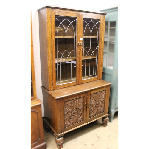 1753 - Carved oak bookcase, having leaded glazed doors (associated top), 95cm wide x 48cm deep x 180cm high