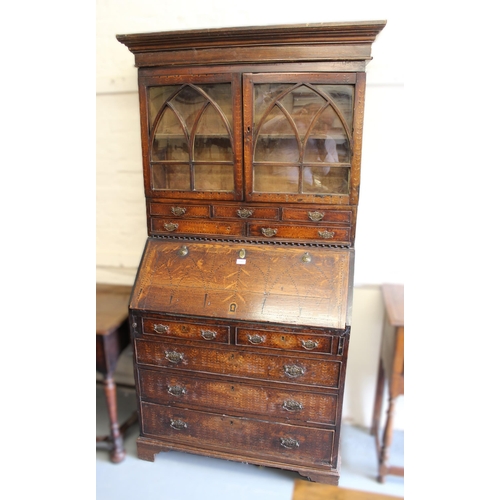 1761 - 19th Century oak inlaid bureau bookcase, having moulded top with arched top glazed doors, an arrange... 