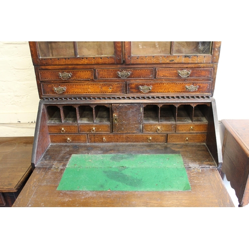 1761 - 19th Century oak inlaid bureau bookcase, having moulded top with arched top glazed doors, an arrange... 