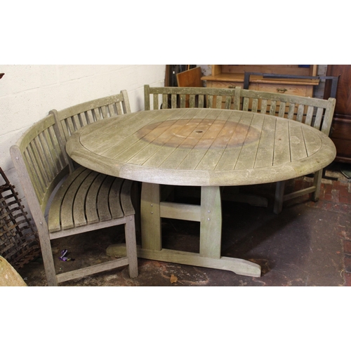 1765 - Large circular teak garden table, 182cm diameter and four curved benches by Nelson