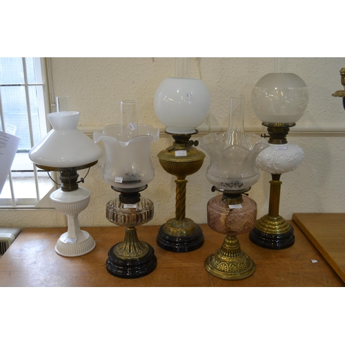 1804 - Group of five various 19th Century brass and opaque glass oil lamps with shades and chimneys