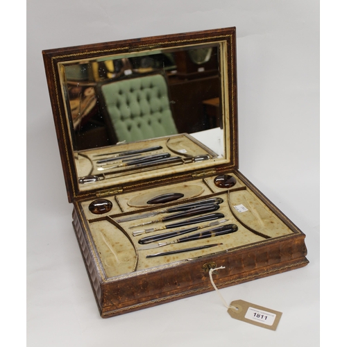 1811 - 19th Century brown leather embossed dressing table manicure box with hinged cover fitted with a mirr... 