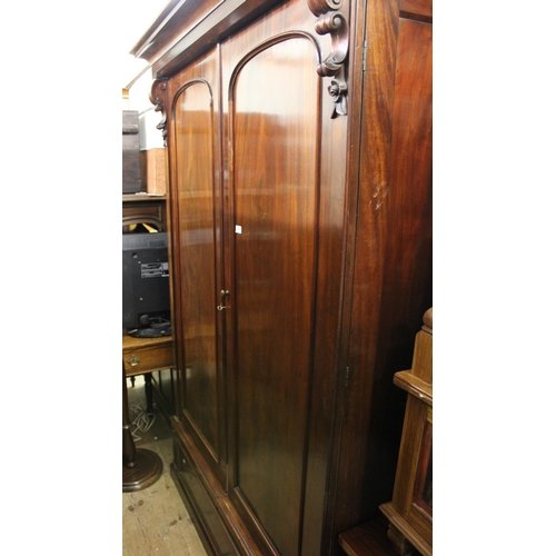 1821 - Victorian mahogany wardrobe with a moulded cornice above two arched panelled doors with drawer below... 