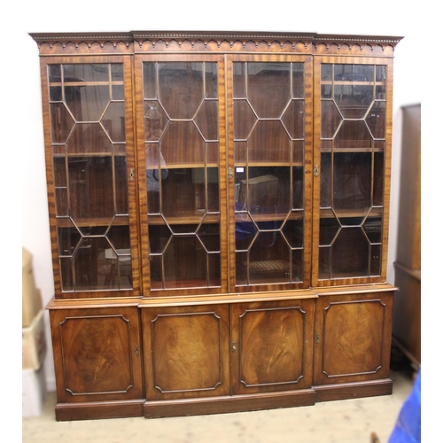 1881 - Reproduction mahogany breakfront bookcase, having four section bar glazed top enclosing adjustable s... 