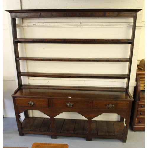 1892 - George III oak dresser, the open shelf back above three drawers and a three bay base with pot shelf,... 